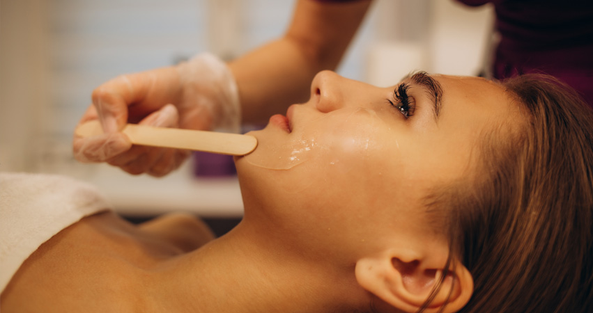 woman having chin waxed